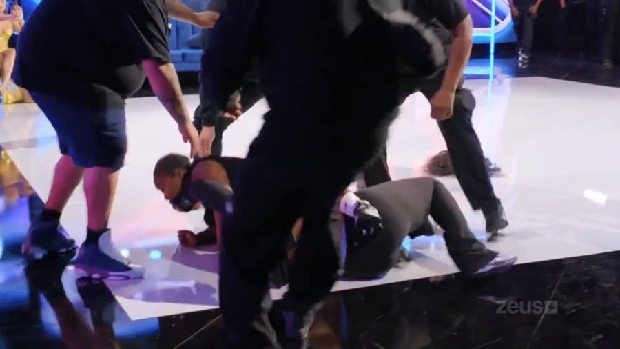 People down on the studio floor during the peak of the altercation, staff intervening
